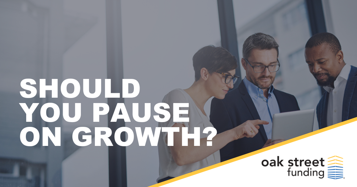 Should you pause on growth? | Three business people meeting over computer